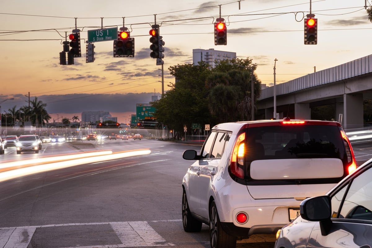 Blurred car traffic on a busy street at sunset