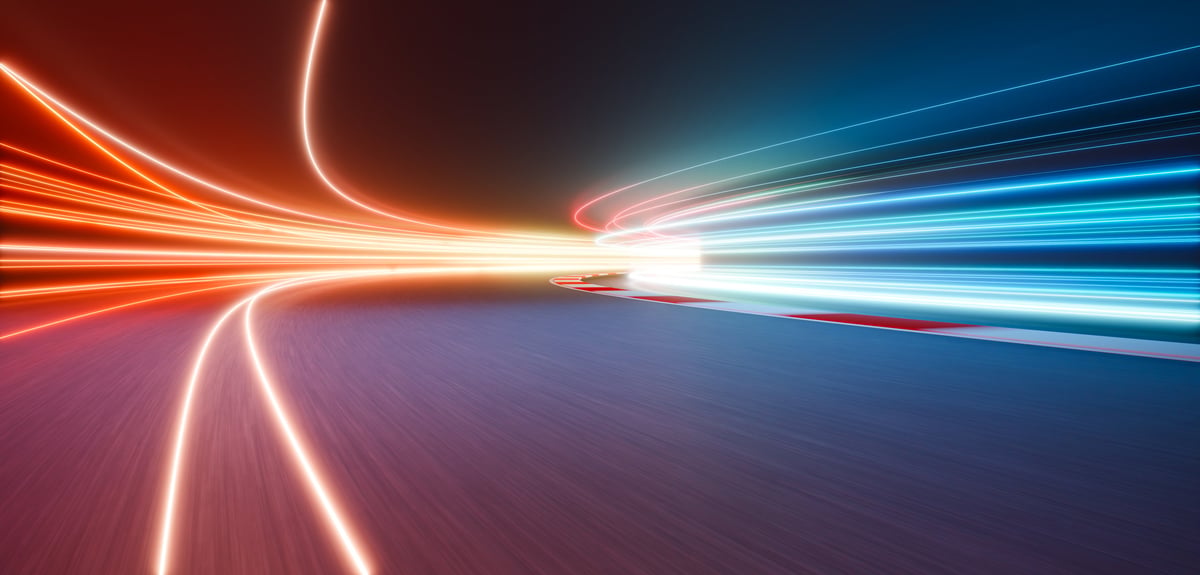 Light trails illuminating a racing track during a night competition